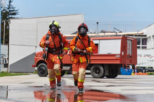 A team of confident and accomplished firefighters strides purposefully in their uniforms, exuding pride and satisfaction after successfully completing a challenging firefighting mission.