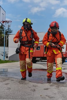 A team of confident and accomplished firefighters strides purposefully in their uniforms, exuding pride and satisfaction after successfully completing a challenging firefighting mission.