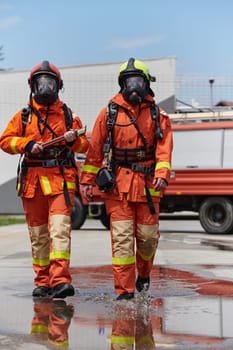 A team of confident and accomplished firefighters strides purposefully in their uniforms, exuding pride and satisfaction after successfully completing a challenging firefighting mission.