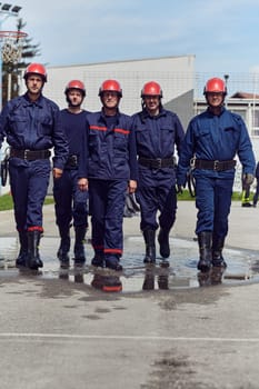 A team of confident and accomplished firefighters strides purposefully in their uniforms, exuding pride and satisfaction after successfully completing a challenging firefighting mission.