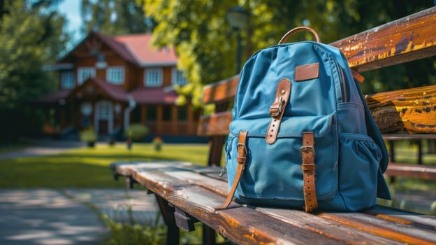 A blue backpack sits on a wooden bench in a grassy field.