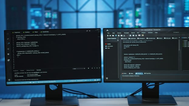Computers in empty data center facility managing rackmounts energy consumption. Close up of script on PC monitors used for automation and monitoring processes in server room, camera B