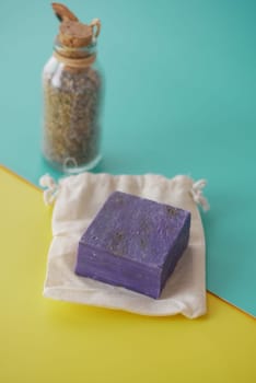 Homemade natural soap bar and lavender flower on table .