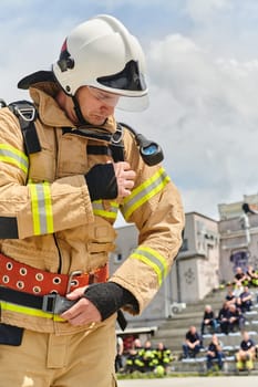 A firefighter dons the essential components of their professional gear, embodying resilience, commitment, and readiness as they gear up for a hazardous firefighting mission, a testament to their unwavering dedication to protecting and saving lives.