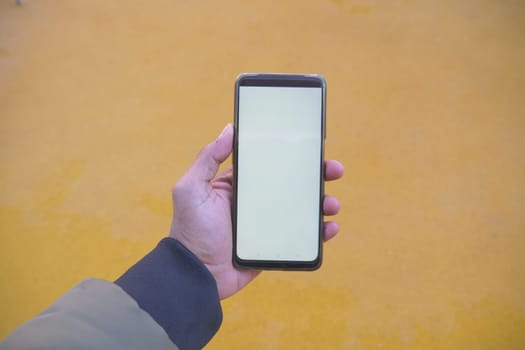 Close up of young man hand using smart phone