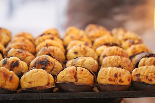 traditional Istanbul street food grilled chestnuts in a row.