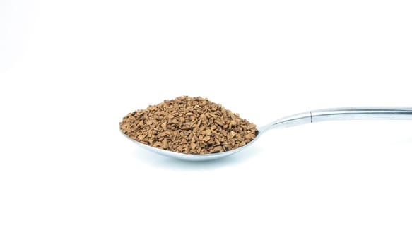 dried instant coffee on a spoon. isolated on white