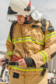 A firefighter dons the essential components of their professional gear, embodying resilience, commitment, and readiness as they gear up for a hazardous firefighting mission, a testament to their unwavering dedication to protecting and saving lives.