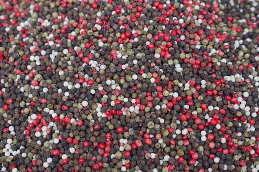 Colorful assorted peppercorns for seasoning and culinary purposes, ideal for enhancing dishes flavor