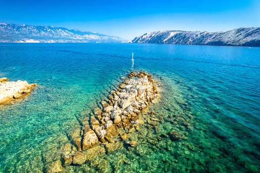 Stone ridge islet in Lopar bay aerial view, Island of Rab in Croatia
