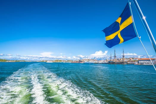 Swedish flag on the boat in Gothenburg islands archipelago near Donso island, Vastra Gotaland County, Sweden