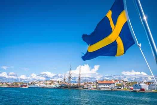 Swedish flag on the boat in Gothenburg islands archipelago near Donso island, Vastra Gotaland County, Sweden