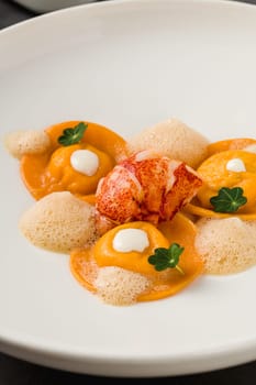 Ravioli with grilled shrimp on a white porcelain plate