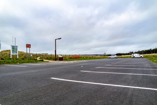MURVAGH, COUNTY DONEGAL, IRELAND - JANUARY 21 2022 : The parking lot at the beach is almost empty.