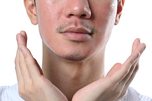 Man touching his face examining complexion after laser skin resurfacing isolated over white background.