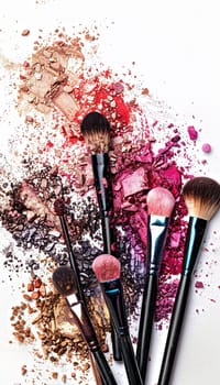 Colorful makeup brushes arranged with eyeshadow and blush on a white background.