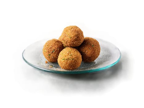 Falafel deep fried and served with tahini sauce on a transparent glass plate Middle Eastern. Food isolated on transparent background.