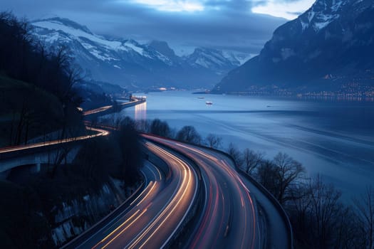 Scenic dusk drive through majestic mountain range with sparkling lake and glowing car lights