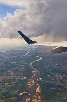 Plane flying over Warsaw, Poland with visible Vistula river