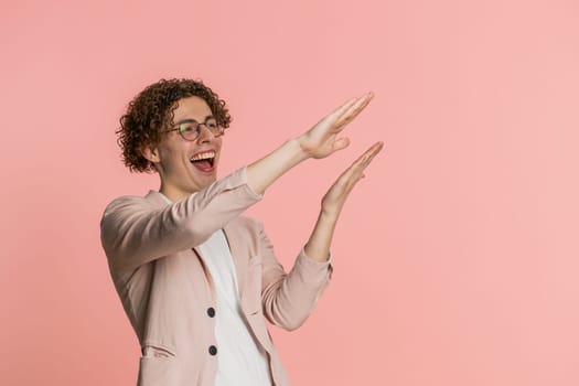 Caucasian curly haired man in jacket showing wasting throwing sharing money around more tips big profit winning lottery jackpot, successful shopping payment purchase cashback. Guy on pink background