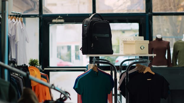 Empty shopping mall with casual or formal wear brands, retail store showroom filled with trendy clothes on hangers and racks. Fashion boutique in clothing center, merchandise on sale. Camera A.