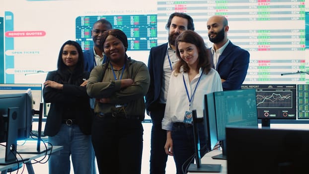 Professional forecast affiliates group posing in monitoring room, making crucial decisions together to ensure objectives accomplishment and work on international business expansion. Camera A.