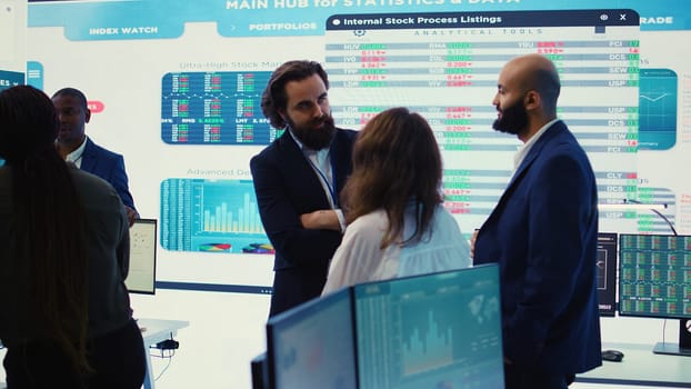 Staff members from a business enterprise discussing details and progress in a new project during a corporate meeting. Company experts getting informed about marketing developments. Camera B.