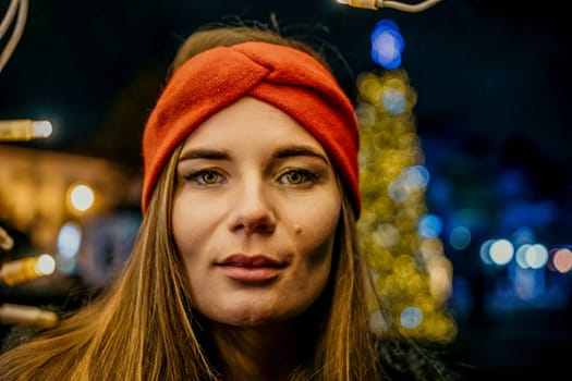 Winter fun on the street: Girl with sparklers, smiles in warm jacket and hat. Festive Christmas or New Year celebration,