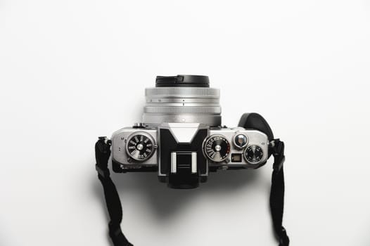 modern camera in retro style with a strap close-up, top view.