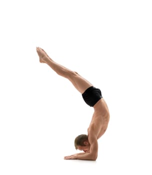 Sport. Athlete doing handstand, isolated on white background