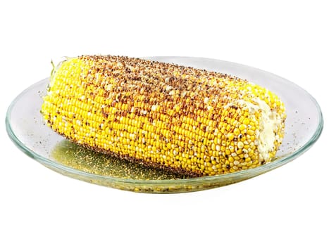 Corn on the cob grilled with butter and spices served on a transparent glass dish. Food isolated on transparent background.