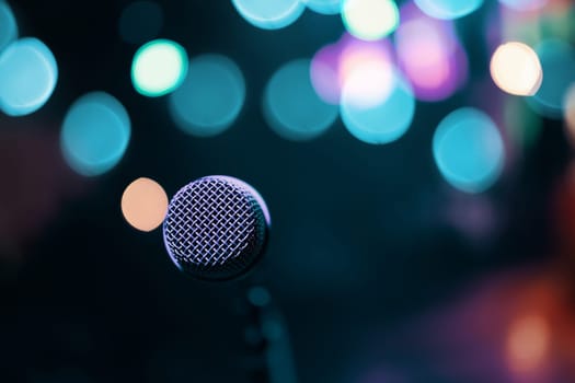 Microphone on colorful background. Stage and retro microphone.