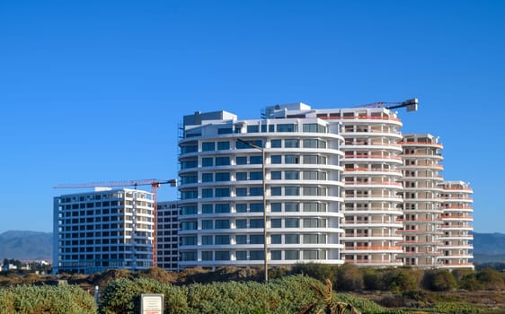 tower crane builds a residential complex near the Mediterranean Sea