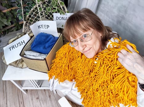 Middle-Aged Woman Sorting Belongings With KonMari Method. Mature woman categorizes items into keep and discard piles