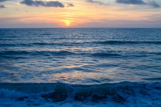 Rocky shoreline bathed in the warm glow of sunset providing a scenic view with copy space image 3