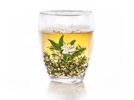 Jasmine Tea Jasmine tea in a clear glass with jasmine flowers releasing their essence misty. Drink isolated on transparent background.