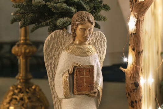 Angel with wings holds a bible in his hands Scene of the birth of Jesus Christ