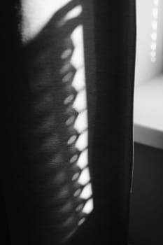 Abstract shadow and striped diagonal light background from window, backdrop and mockup design shadow of the rays falling on the wall through curtains. black and white