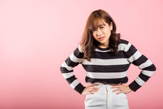 Portrait of Asian beautiful young woman has stomachache, female abdominal pain suffering from stomach ache, studio shot isolated on pink background, period pain, Health and medical gastritis concept