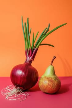Fresh pairing of red onion and pear on vibrant orange surface with copy space for culinary or food concept background