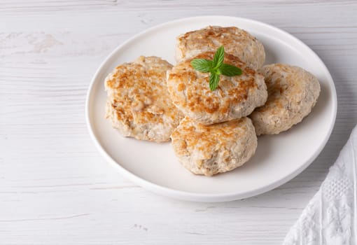 Roasted chicken cutlets on white plate.