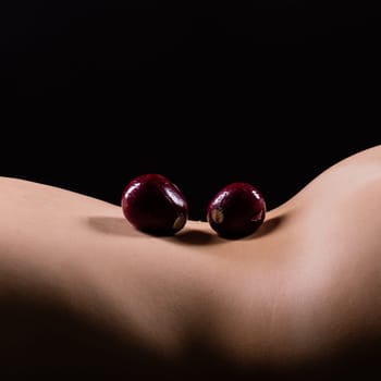 Close up of a woman back with laying onion, low key
