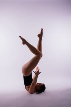 Beautiful woman doing poses on a yoga class. Studio shot.