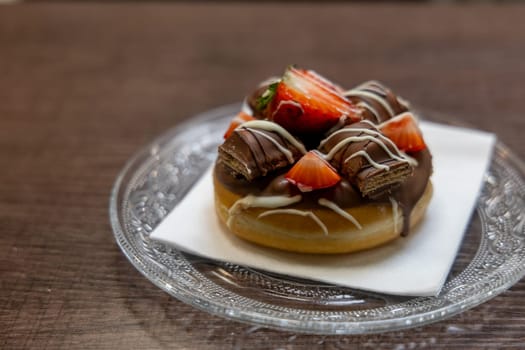 A delicious dessert composed of a chocolate base layered with fresh strawberries and topped with a single strawberry