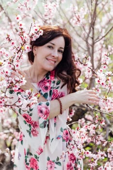a woman near pink flowering trees in peach garden nature spring
