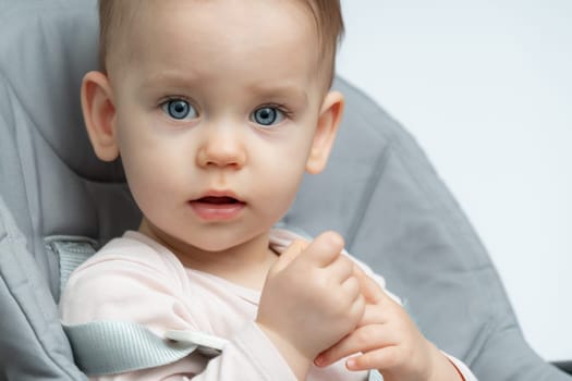 Close-up of an infant baby gazing at the camera with wide-eyed wonder