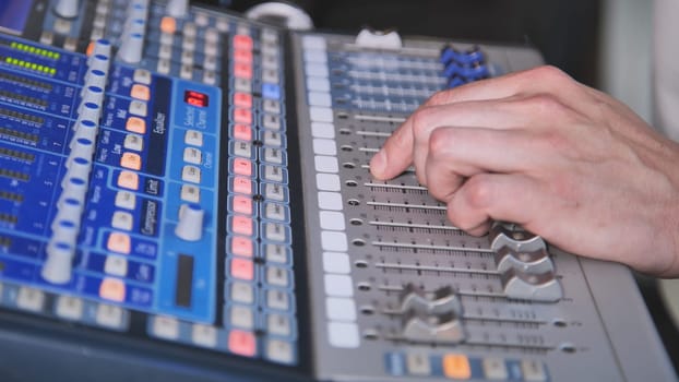 Sound control panel professional. Sound designer working on the sound control. Man working on professional digital audio channel mixer in studio.