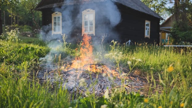 Burning branches outside the village house