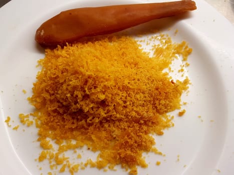 A partially grated mullet bottarga ready to season a dish.