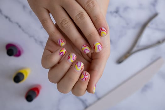 Woman manicured hands, stylish summer colorful nails. Closeup of manicured nails of female hand. Summer style of nail design concept. Beauty treatment.